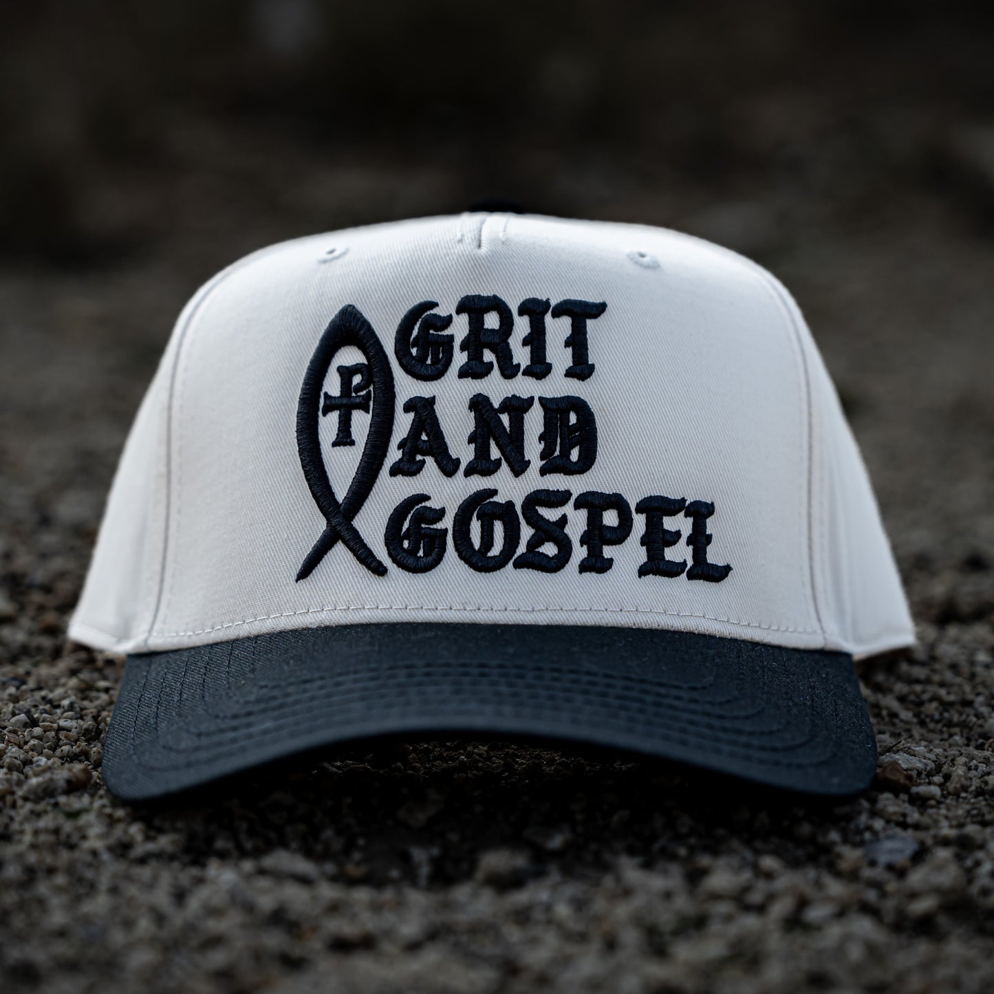 Front of two-tone Otto snapback hat with Grit and Gospel puff embroidery black color christian apparel Ichthys